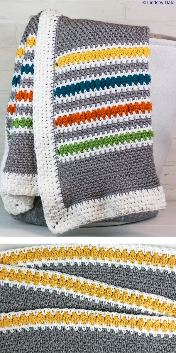 modern stripes throw blanket in mainly grey color with a white boarder and thinner yellow blue orange and green lines