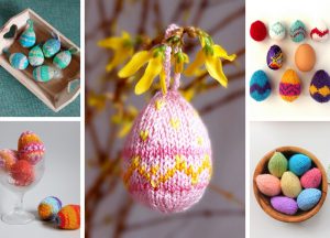 A vibrant array of colorful, knitted Easter eggs adorns the scene, nestled in a wooden box, a wine glass, and a bowl, while others dangle elegantly from a branch.