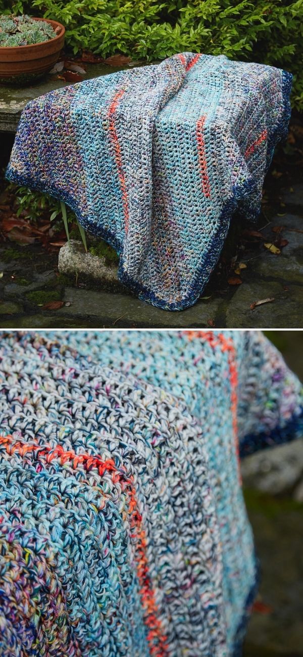 rustic-looking striped bias blanket made with scrap yarn presented in a garden on a stone bench