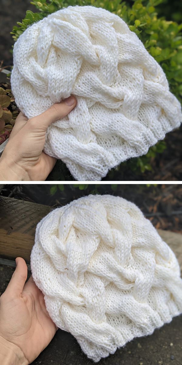 white knitted cabled beanie in someone's hand