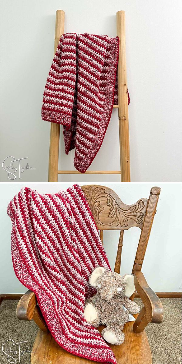 crochet stripe baby blanket in burgundy and pale pink colors hanged on a wooden ladder
