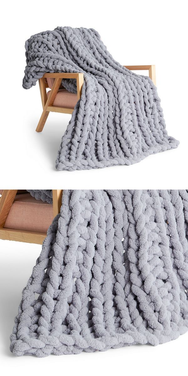 grey bulky knitted throw with cable design placed on an old-fashioned armchair