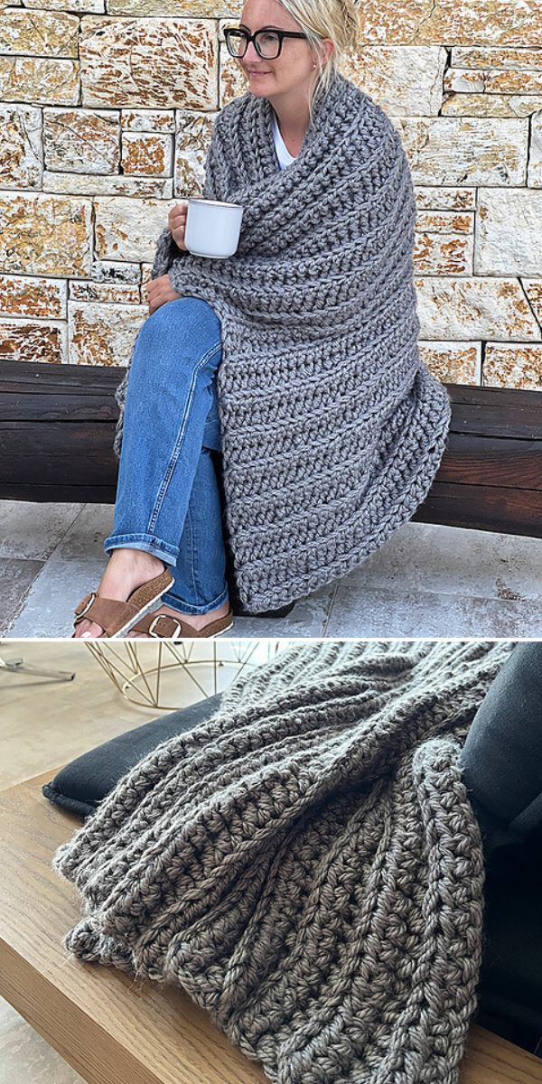 a woman is sitting with a cup of tea wrapped in a grey crochet chunky blanket