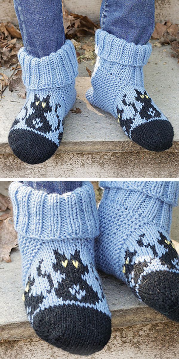 A pair of knitted baby socks with a cat on them.