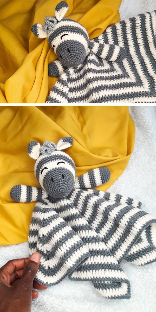 A crocheted zebra lovey lying on a bed.