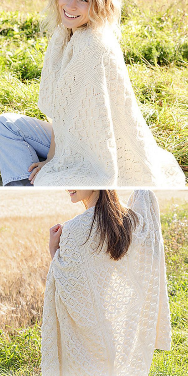 A woman wearing a white poncho while holding knitted baby blankets.