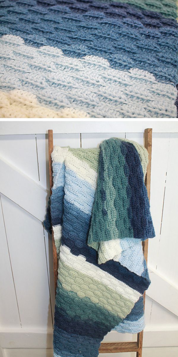 A wavy crochet blanket in shades of blue and green draped over a wooden chair.