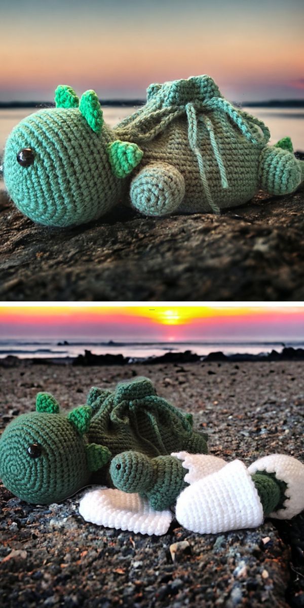 Handmade amigurumi toys resembling dragons resting on the beach at sunset.