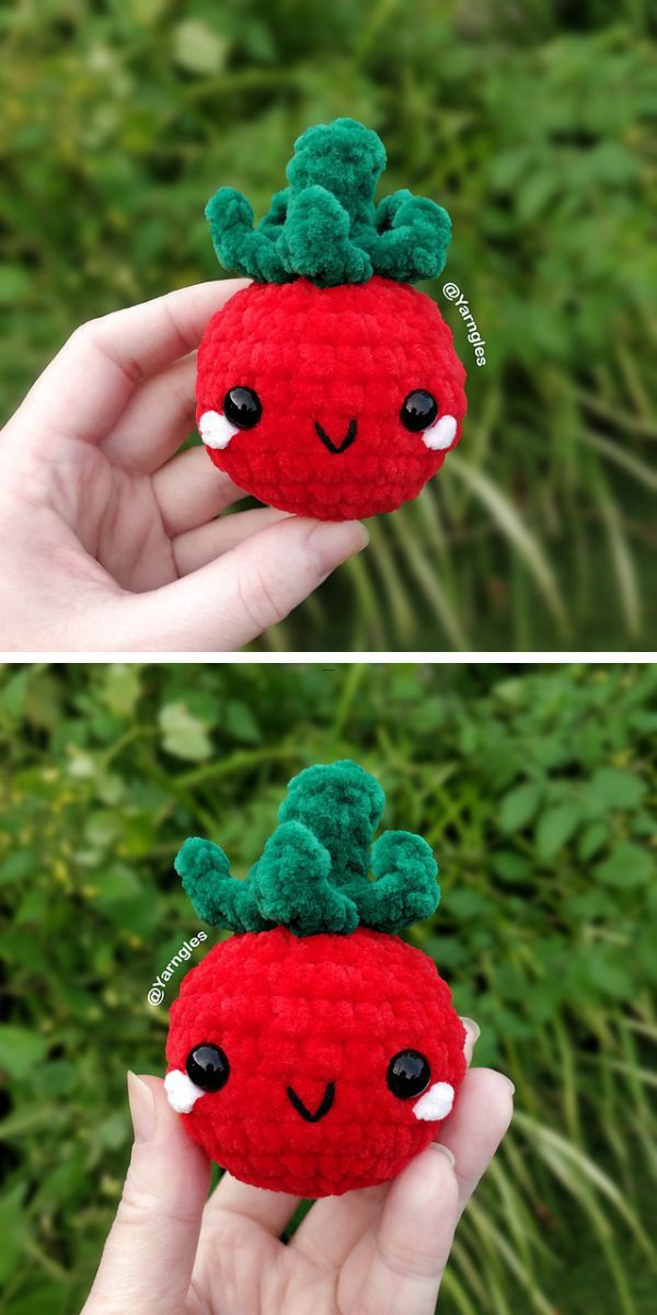 a red crochet tomato amigurumi with a smiley face held by a person