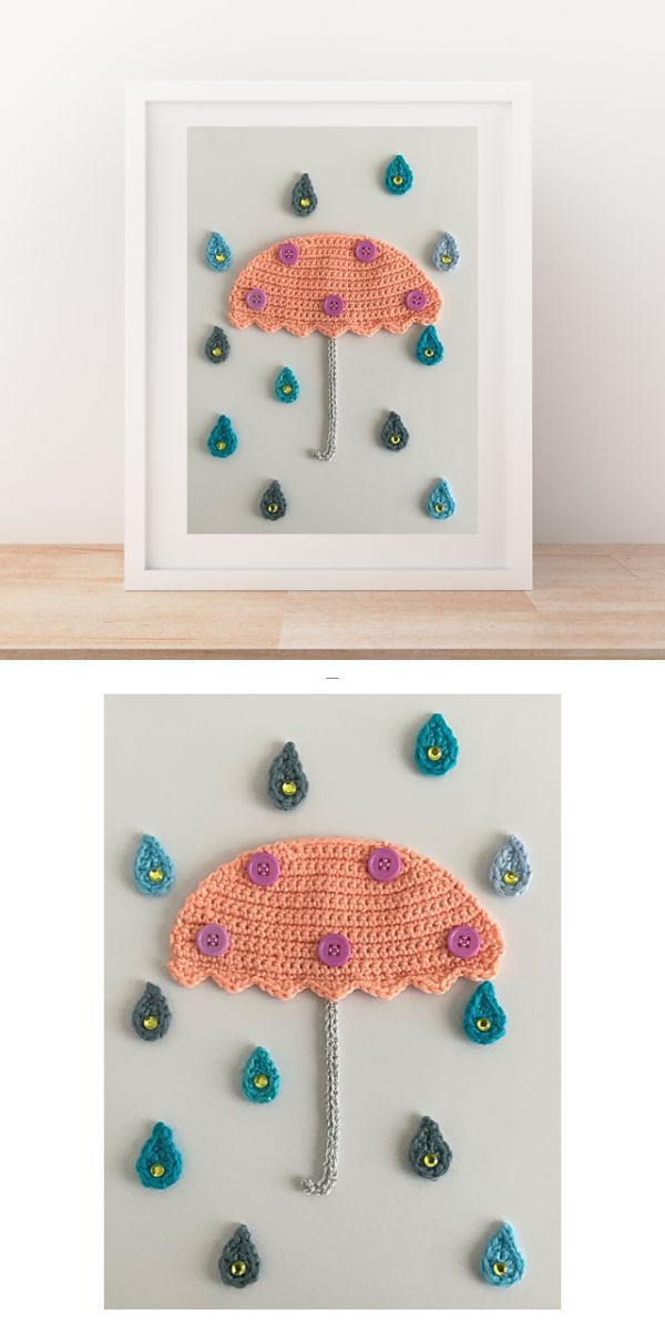 a crochet umbrella with raindrops appliques placed in a photo frame