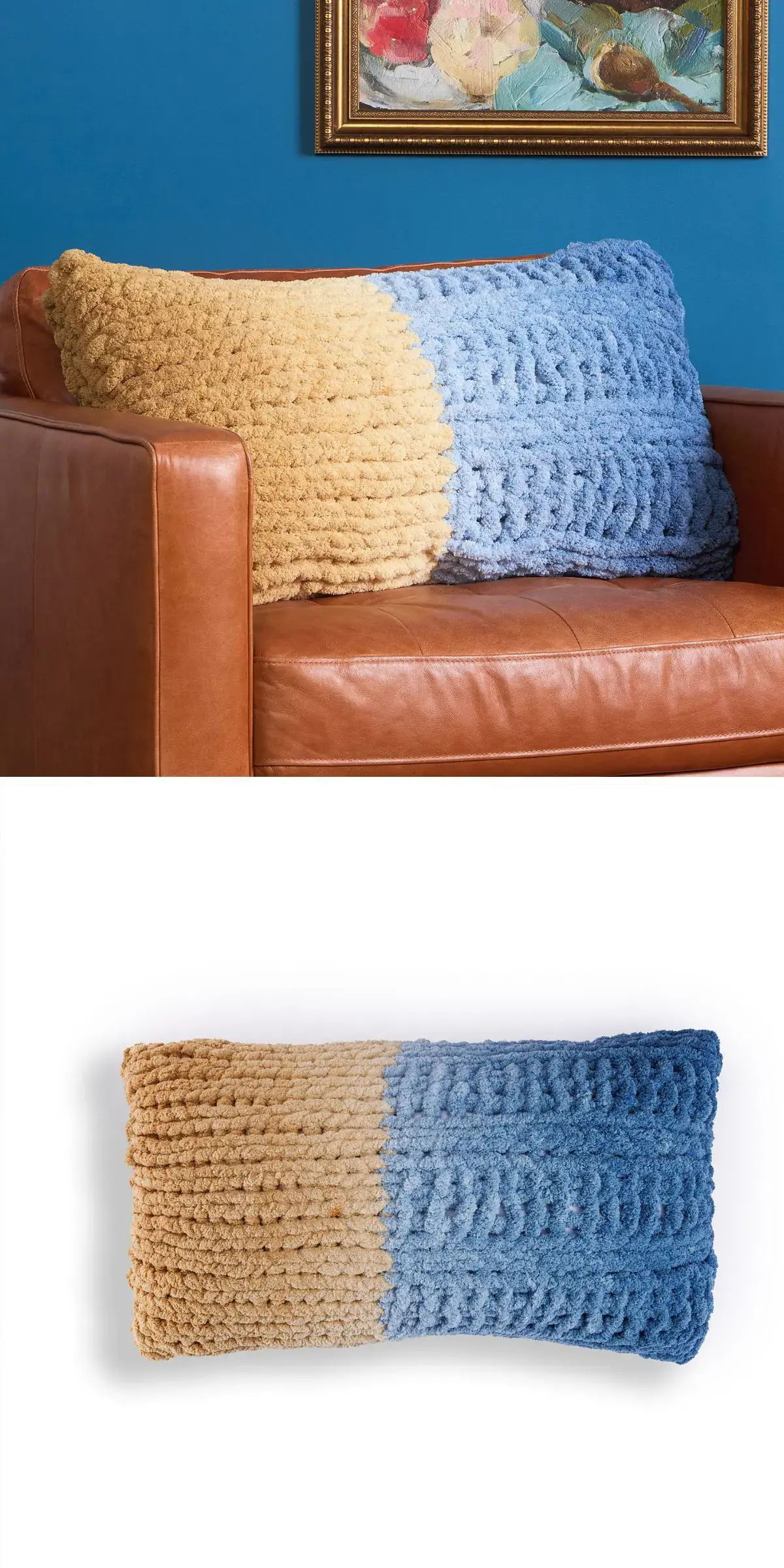 A textured, two-toned, knitted pillow with beige and blue halves rests on a brown leather couch.