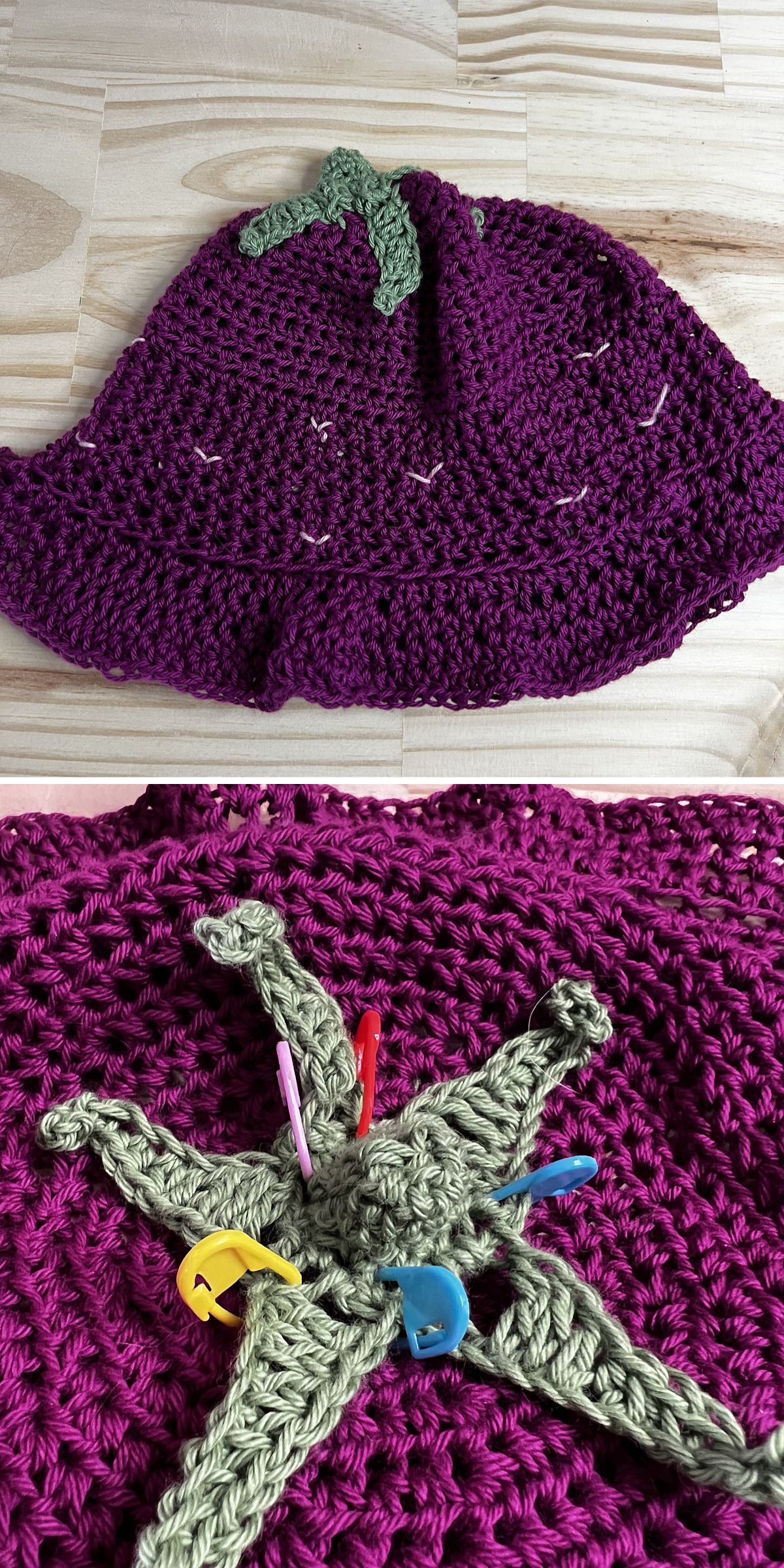 a crochet baby hat with a strawberry-themed design in a dark purple color