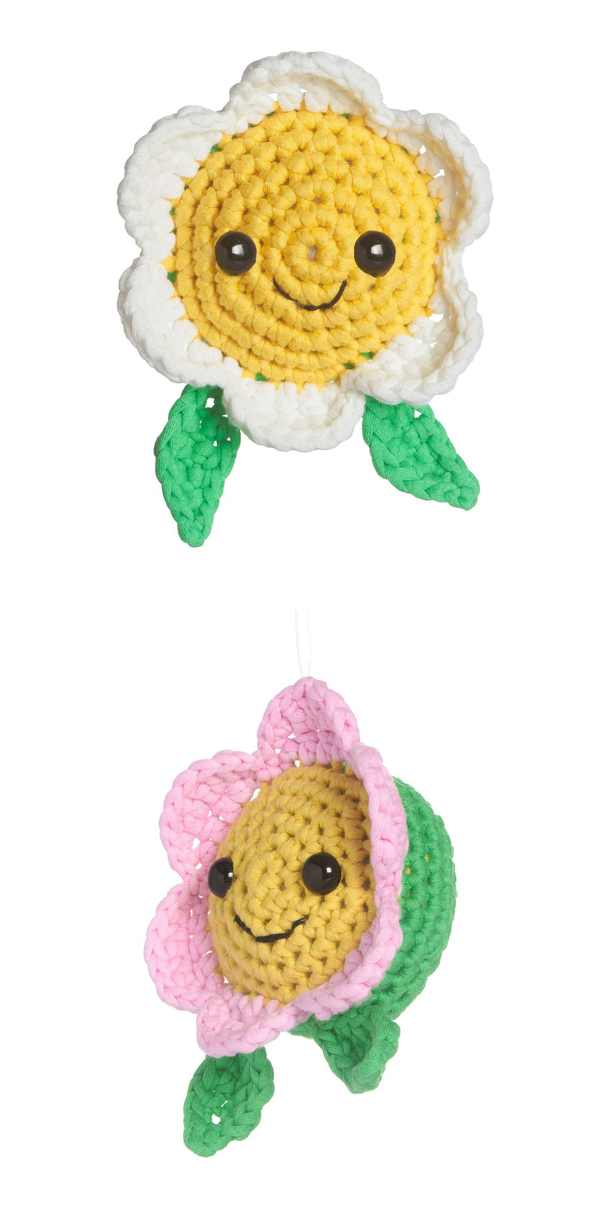two crochet daisy flowers with smiling faces