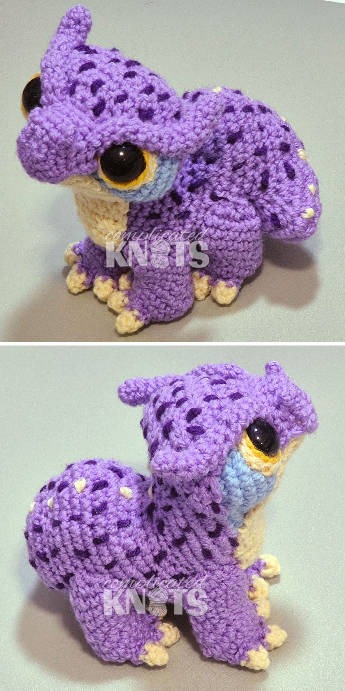 a crochet dragon amigurumi in purple with big eyes