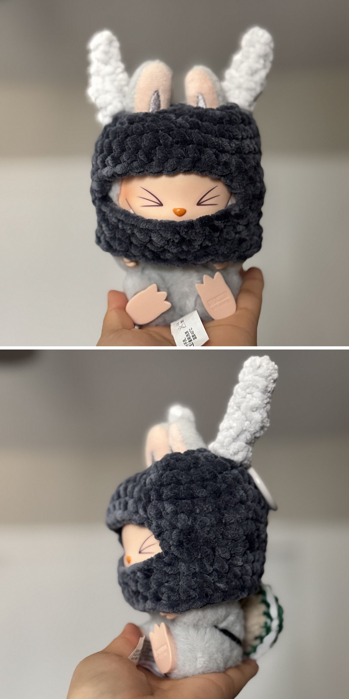 A plush Labubu toy with closed eyes, bunny ears, and a dark gray crochet hood — perfect for pairing with crochet doll clothes — is held up by a hand; side and front views are shown.