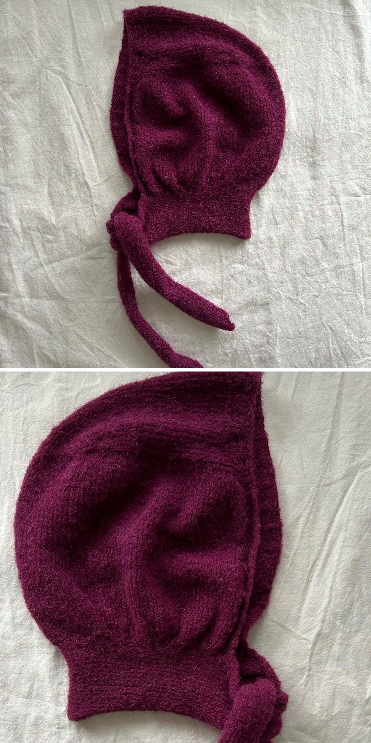 A deep purple knitted bonnet for adults with ties, displayed on a white fabric background in two different close-up angles.