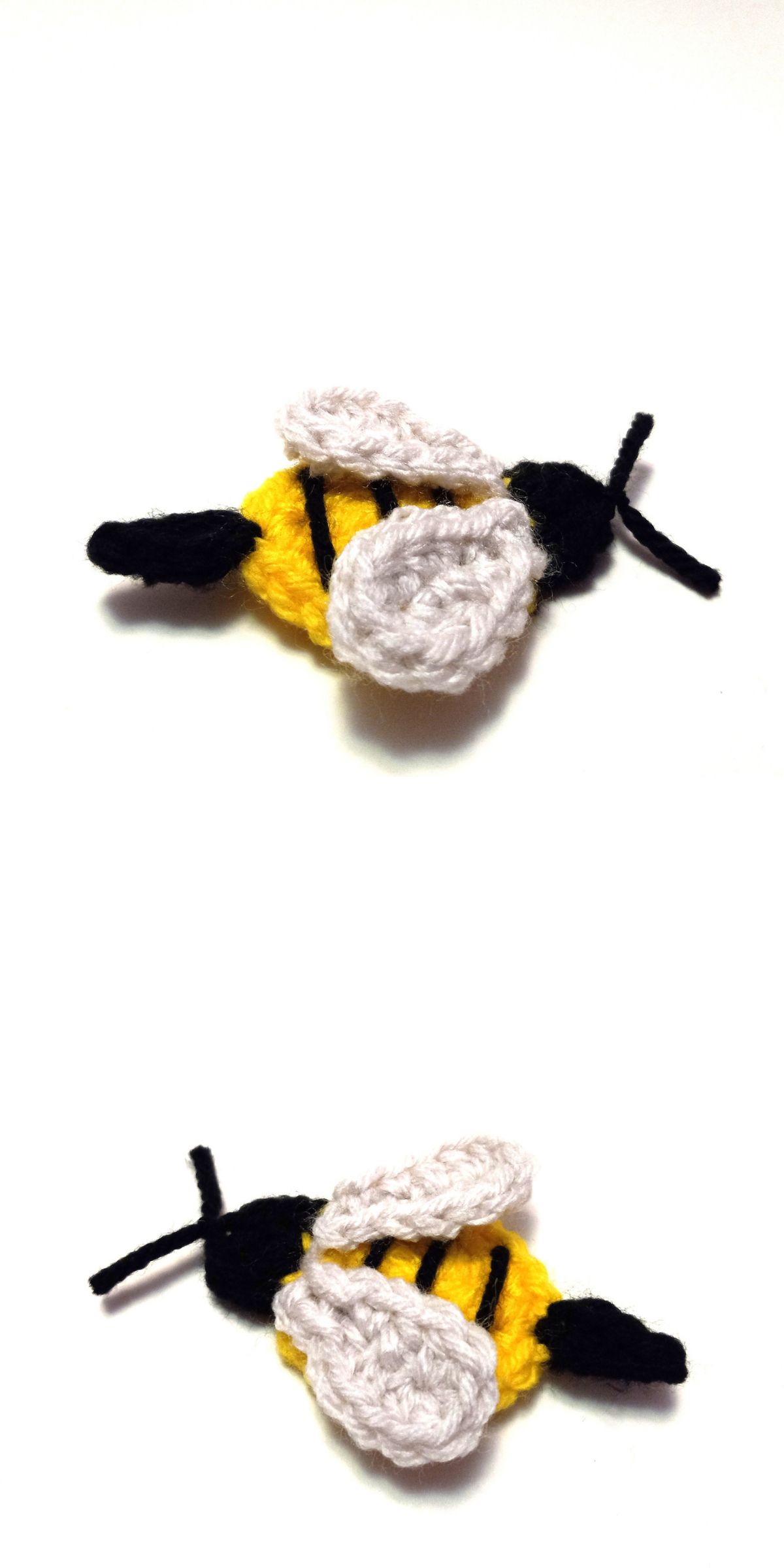Two crochet bee appliques with yellow bodies, black stripes, black heads, and white wings are shown on a white background.