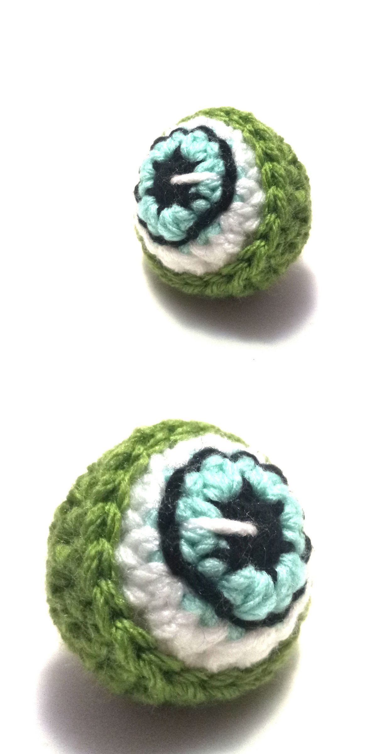 a green crochet eyeball