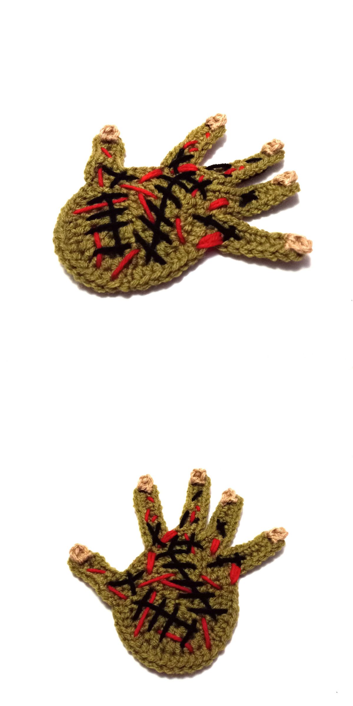 a crochet zombie hand coaster