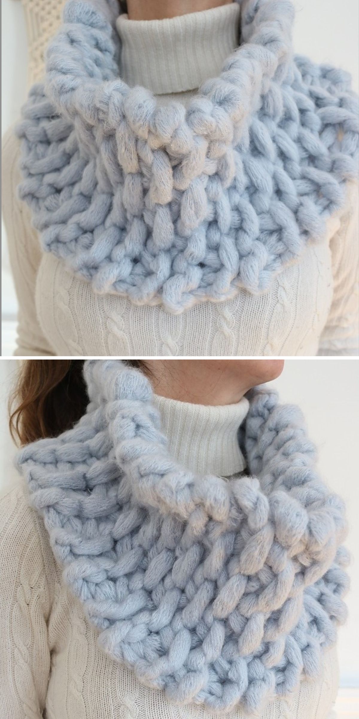 A person wears a chunky, light blue knitted cowl over a white cable-knit turtleneck sweater.