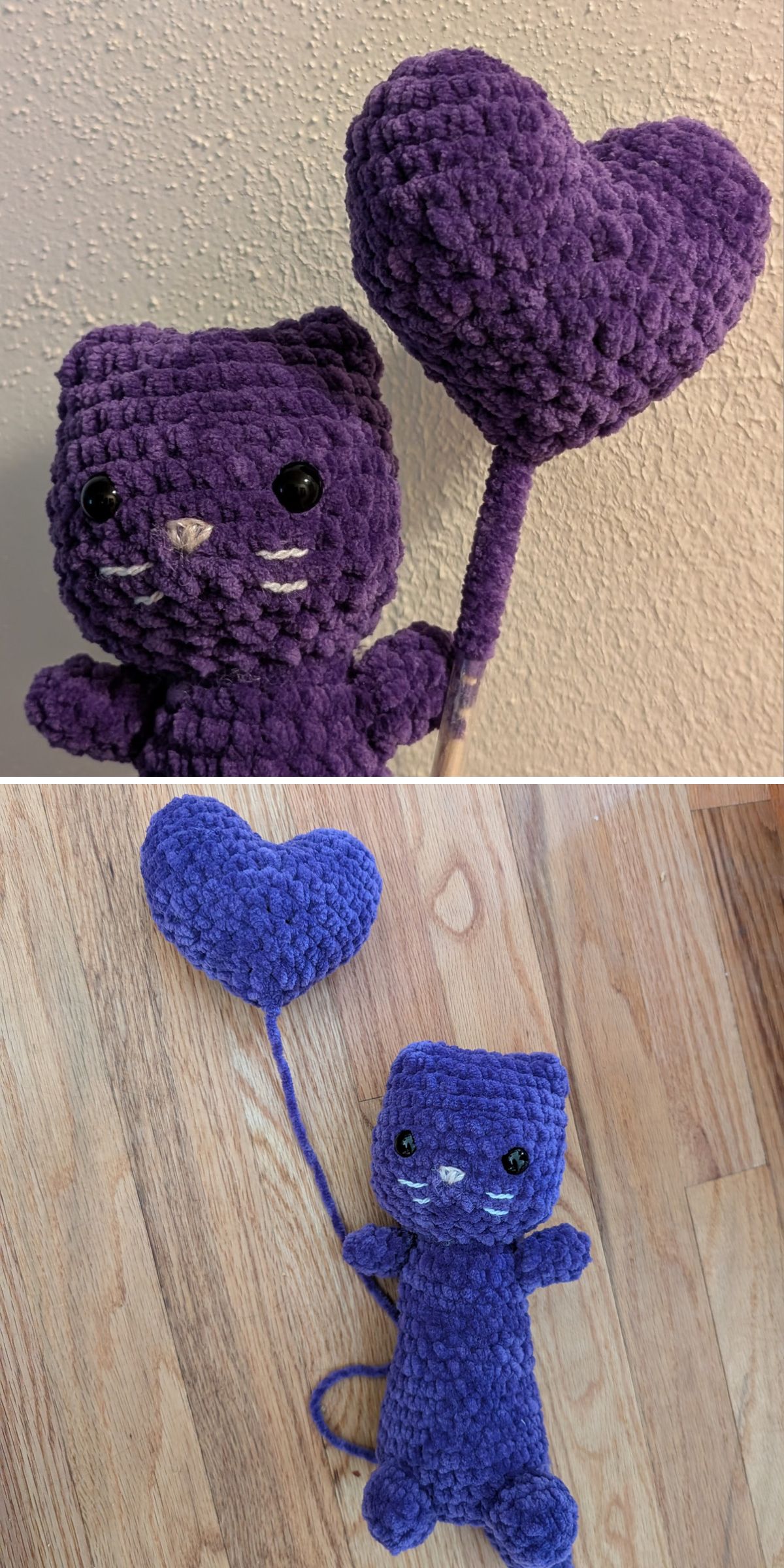 A crochet cat amigurumi plush in purple holds a matching heart-shaped balloon, shown close up against a wall and lying flat on a wooden floor.