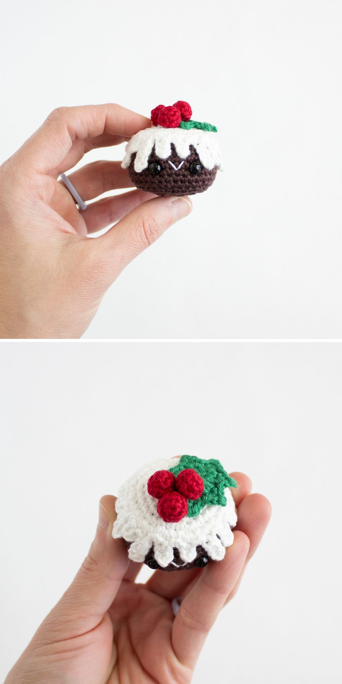 A hand holds a small crochet amigurumi food: a Christmas pudding with white icing, red berries, and green leaves.