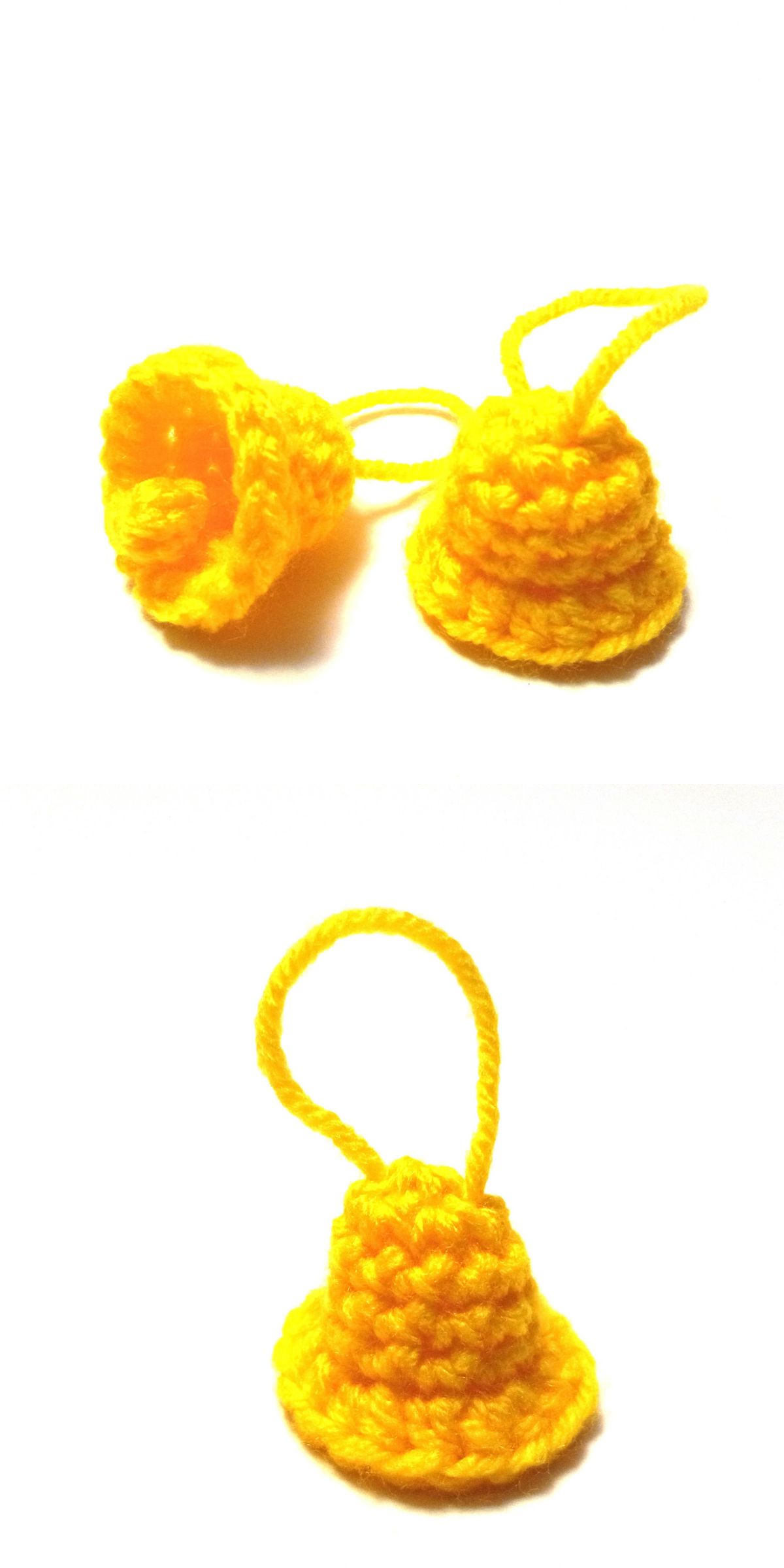 Two small, yellow, crochet Christmas bells with hanging loops are shown on a white background.