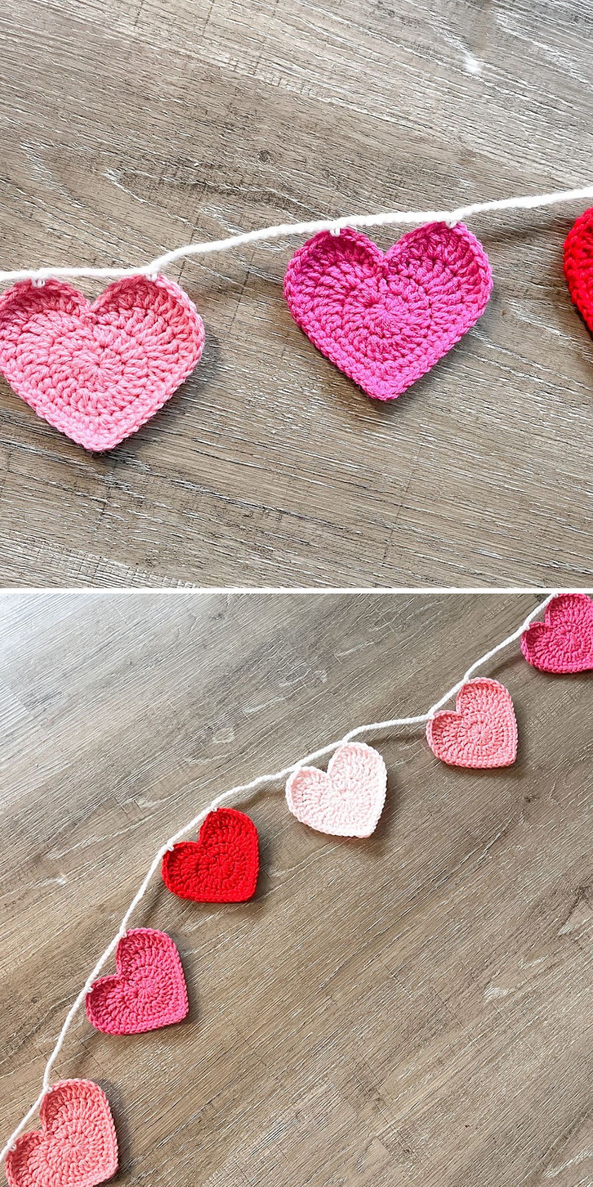 A string of crocheted hearts in pink, red, and light pink is beautifully displayed on a wooden surface.