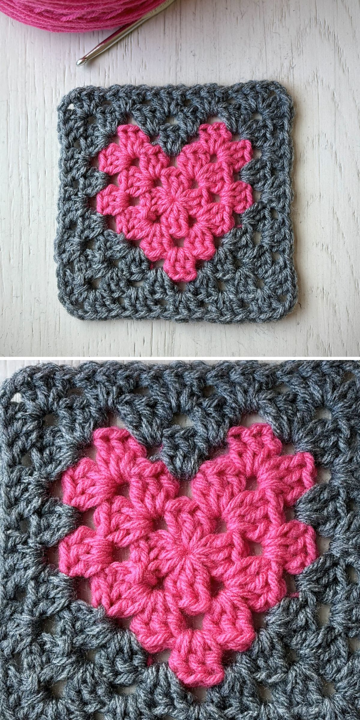 A crocheted square featuring a crochet heart pattern in pink at the center, bordered by gray yarn, and placed on a light wooden surface.