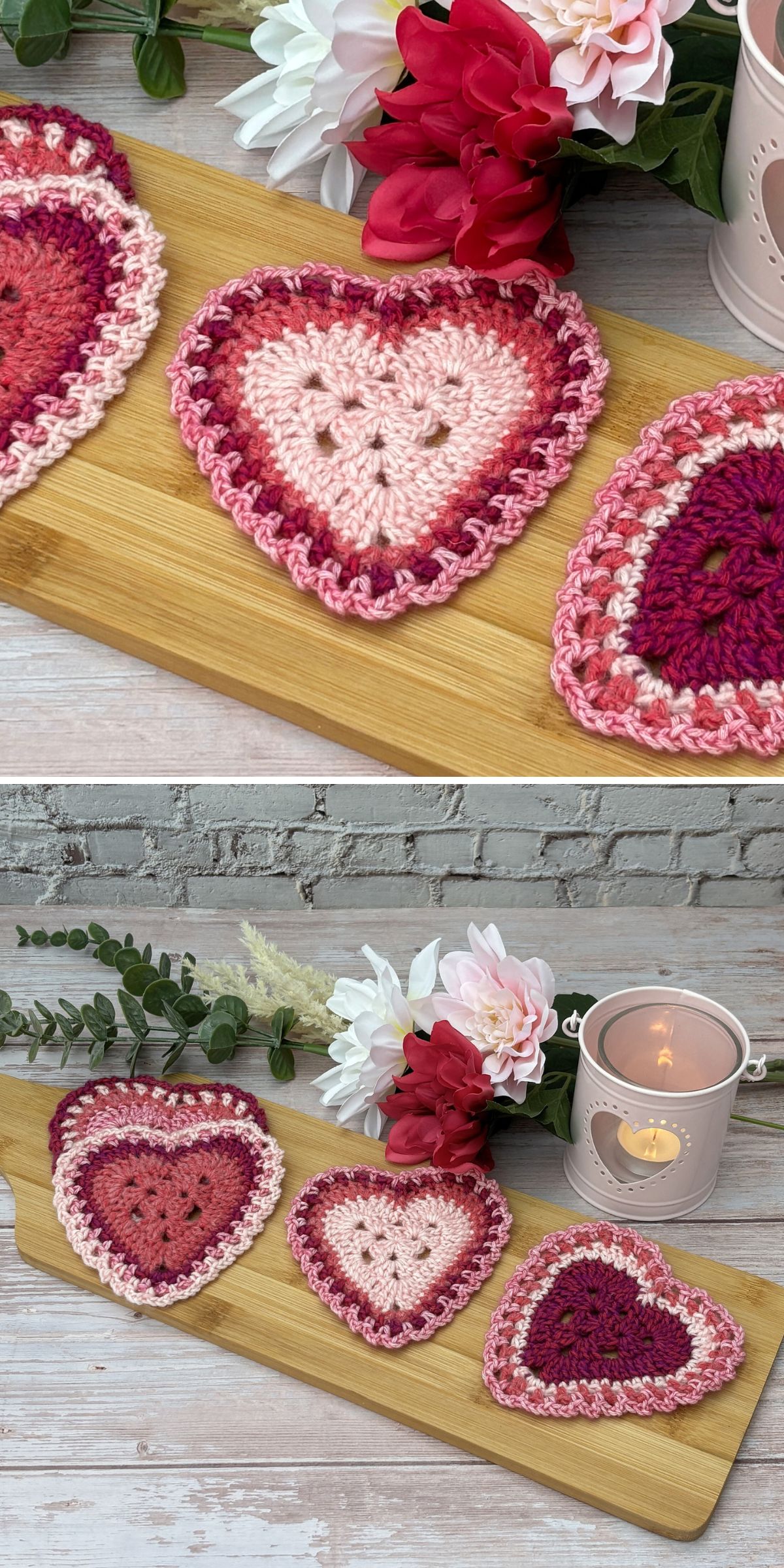 Three crochet heart-shaped coasters in shades of pink and red are displayed on a wooden board, with flowers and a lit candle in the background.