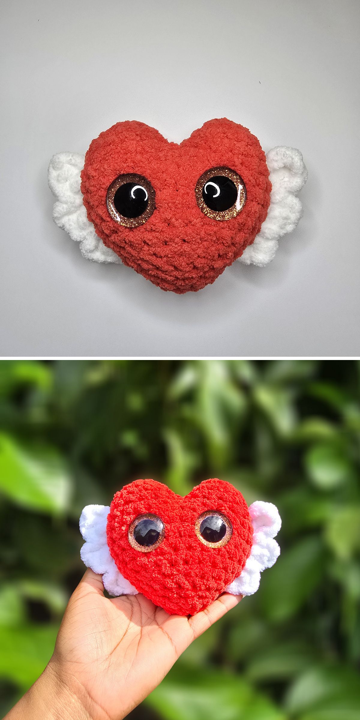A red, heart-shaped plush crochet heart with large black eyes and white wings is shown against a white background and being held outdoors.