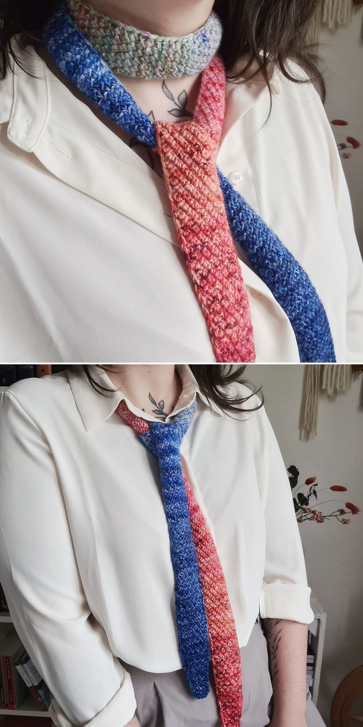 A person wearing a white button-up shirt and a multicolored knit skinny scarf, featuring blue, red, and pink sections inspired by knitting scarf patterns. The person has long hair and a tattoo on their upper chest.