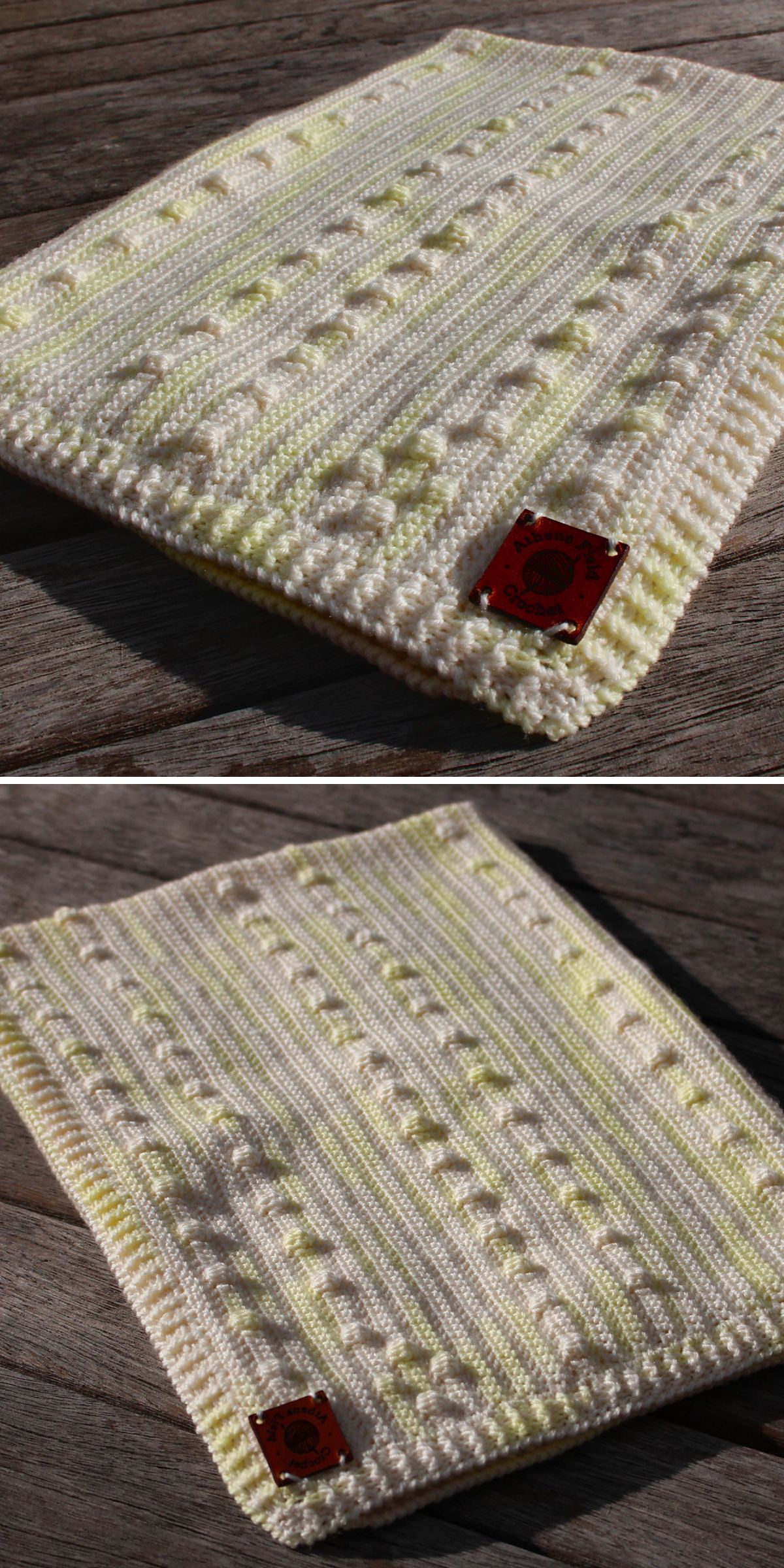 A square, hand-crochet bobble stitch blanket featuring cream and light yellow stripes with textured patterns, and a red tag sewn on one corner, is displayed on a wooden surface.