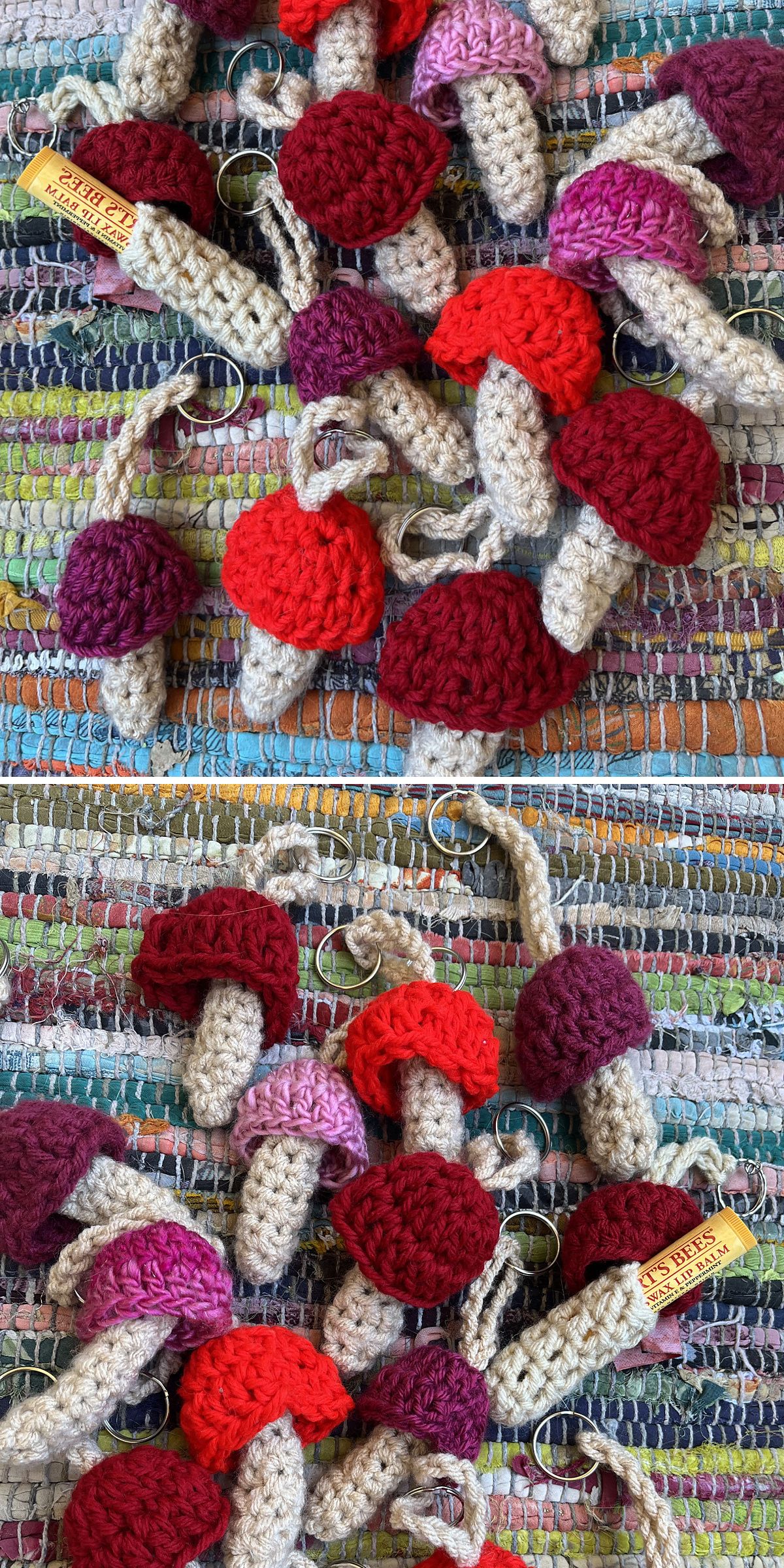 A pile of crochet mushroom amigurumi keychains with red, burgundy, and pink caps rests on a multicolored woven fabric background.
