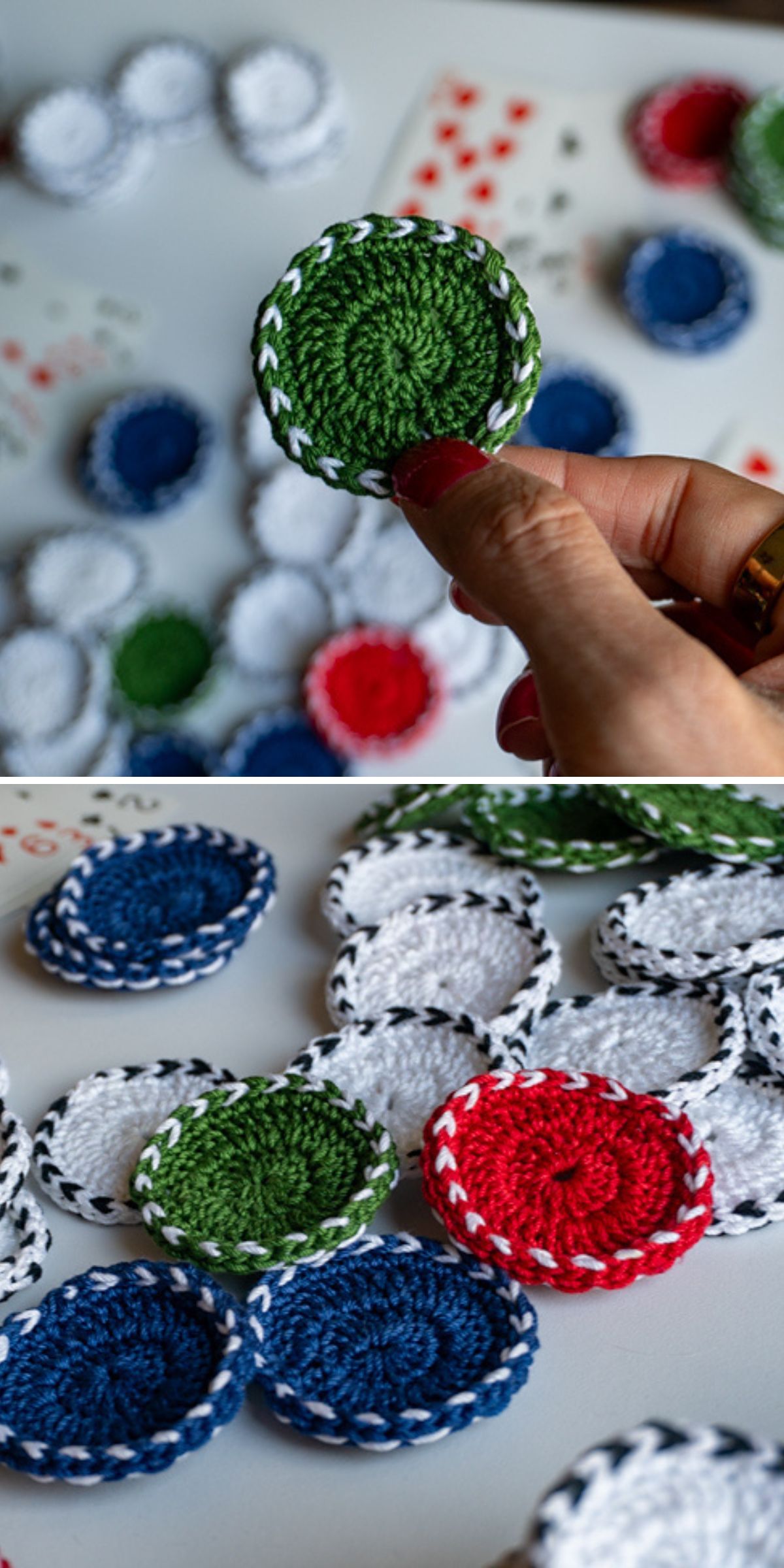Close-up of a hand holding a round, crocheted green token with black and white edging, with more crochet baby toy tokens in red, blue, white, and green scattered on a surface.