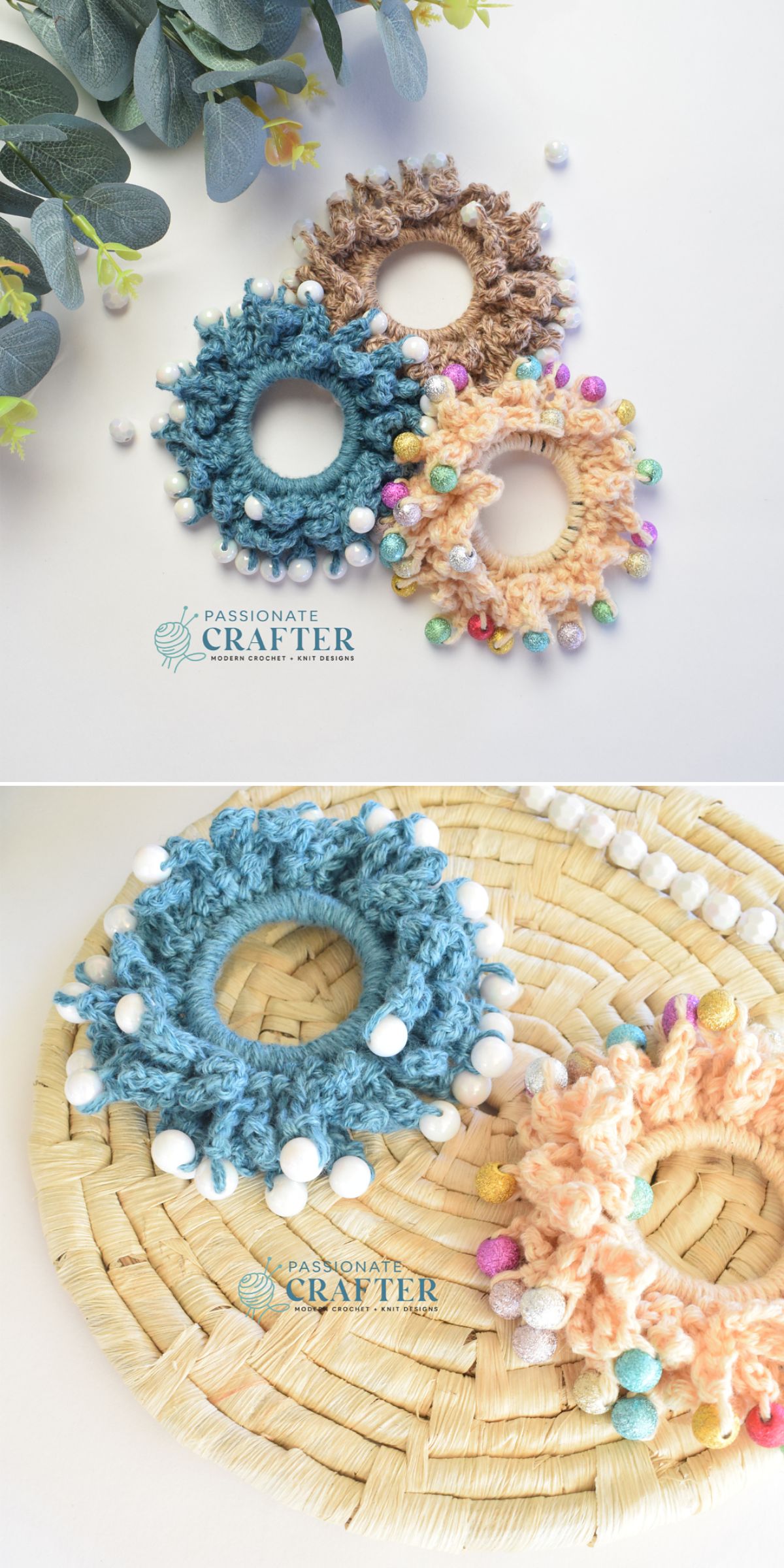 Three round crochet scrunchies in blue, tan, and peach with colorful or white pom-poms, displayed on a wicker surface and next to green leaves.