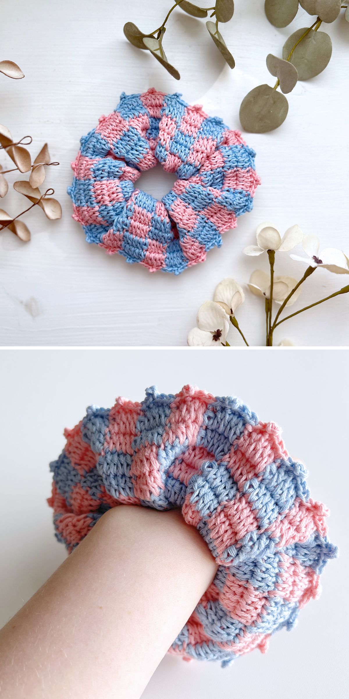 A crochet scrunchie with a pink and blue checkered pattern is displayed on a white surface with dried flowers and shown worn on a wrist.