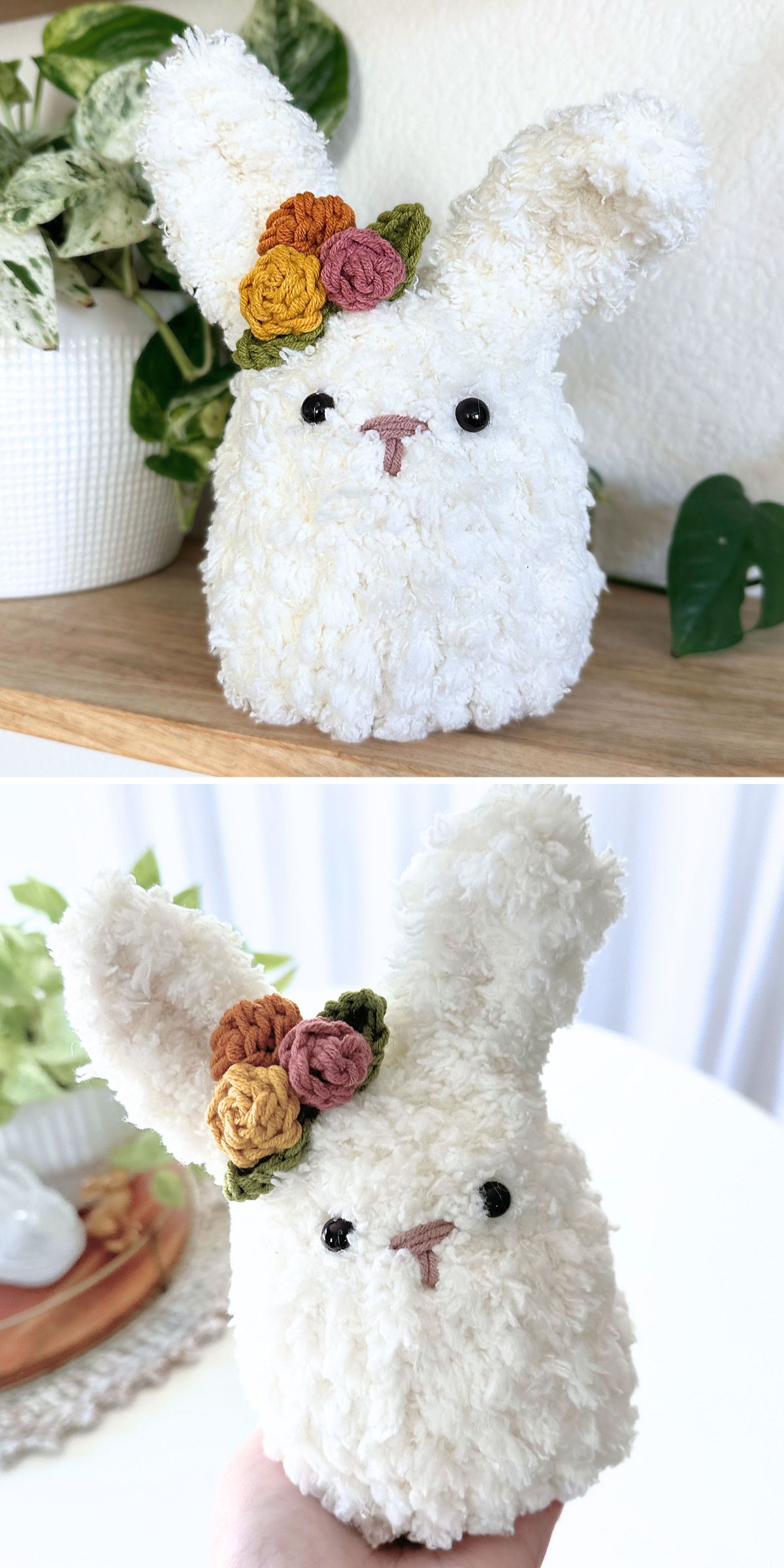 A crochet bunny with black eyes, a pink nose, and three crocheted flowers on its head is displayed on a wooden shelf and shown being held in a hand.