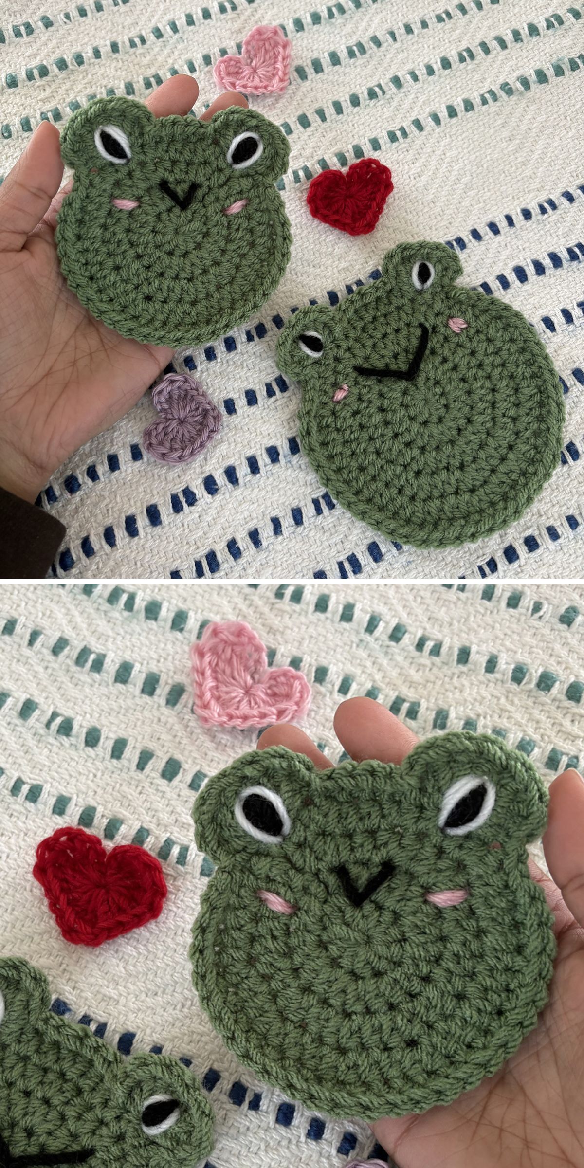 Two crochet frog faces are held in hand, surrounded by crocheted red hearts and a pink heart, all resting on a textured white and blue background.