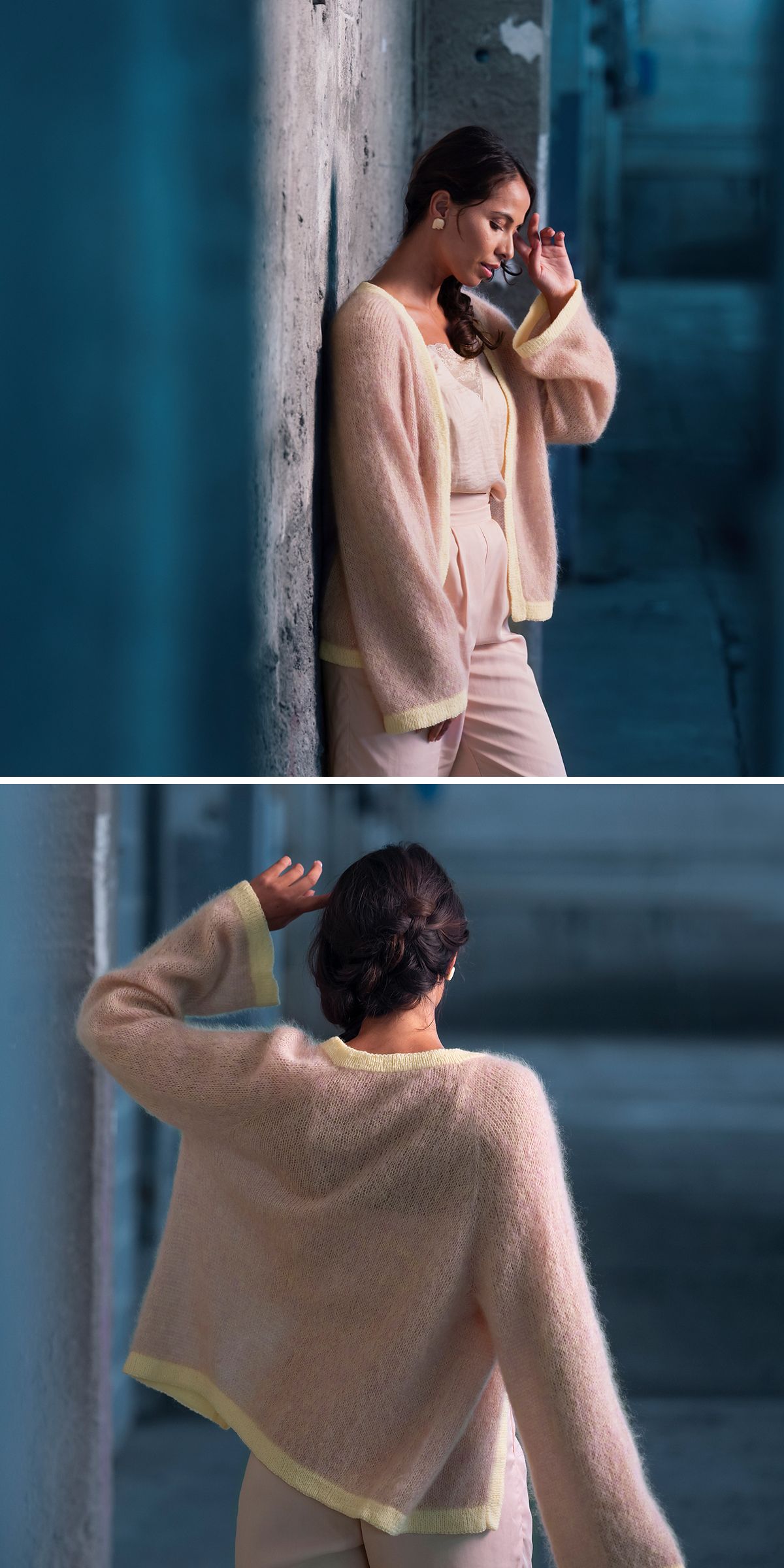 A woman in pale pink pants and a fuzzy beige cardigan with yellow trim stands and leans against a concrete wall — her look echoes inspiration found in Free Knitting Patterns for Cardigans, perfect for urban style.