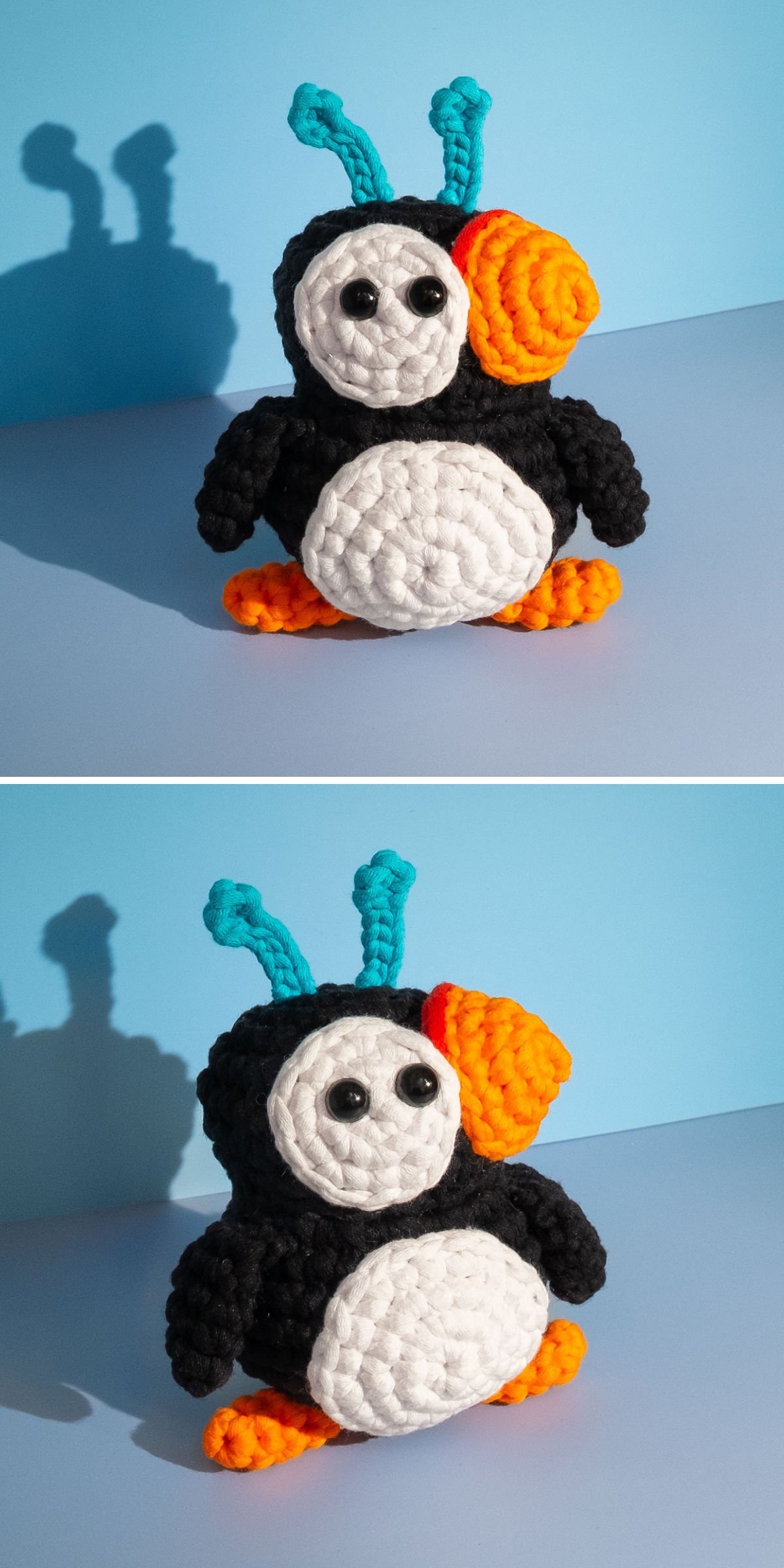 A crochet bird puffin plush with black, white, orange, and blue yarn, featuring large eyes and standing on a flat surface against a blue background.