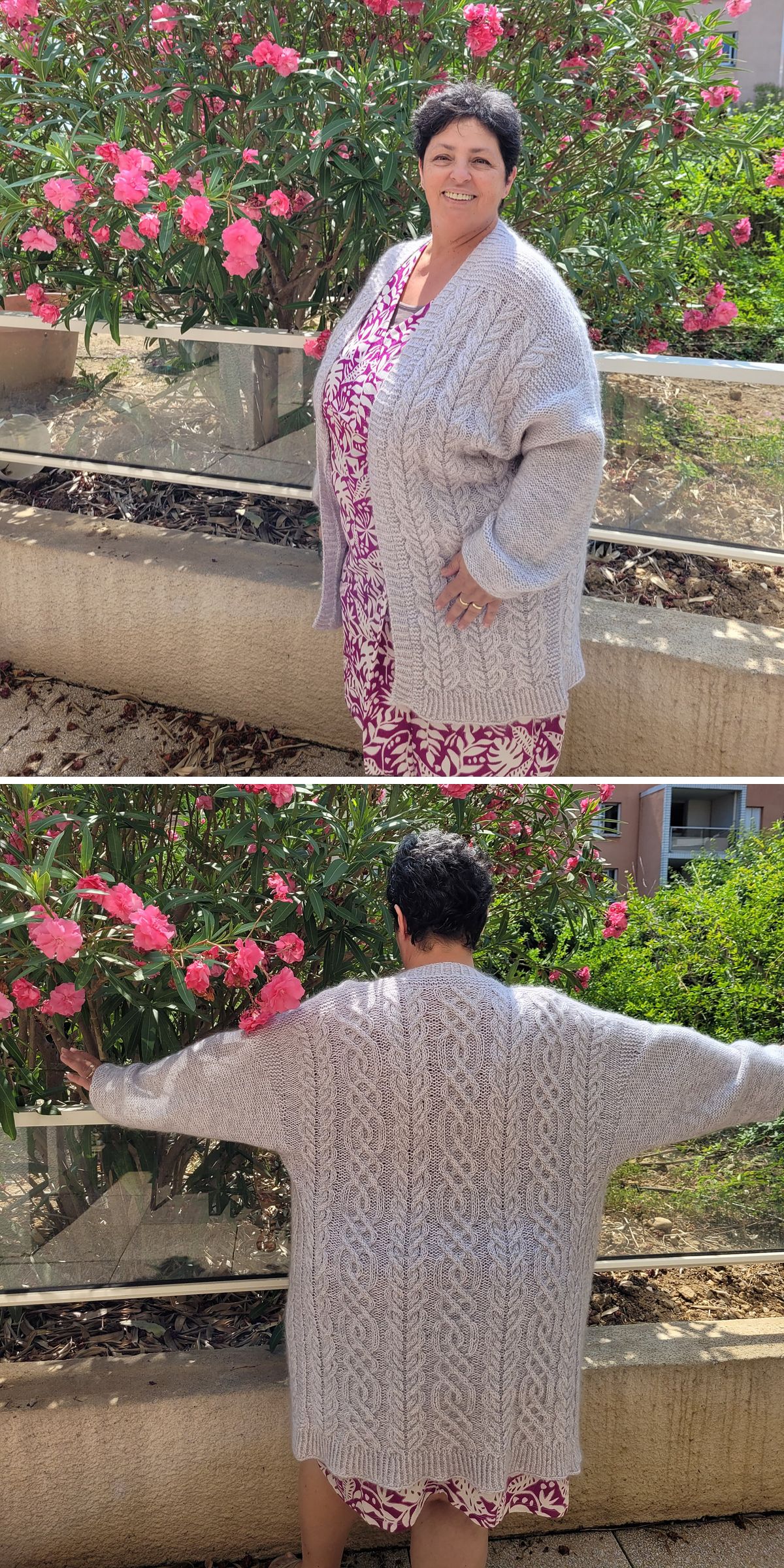 A person wearing a light gray, cable-knit cardigan—perfect for those seeking Free Knitting Patterns for Cardigans—over a patterned dress stands in front of pink flowering bushes, shown from both front and back angles.
