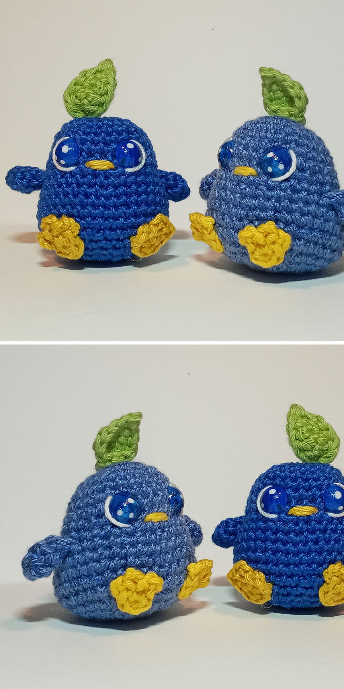 Two pairs of handmade crochet bird plushies feature blue bodies, yellow wings and feet, and green leaf crests, beautifully displayed on a white background.