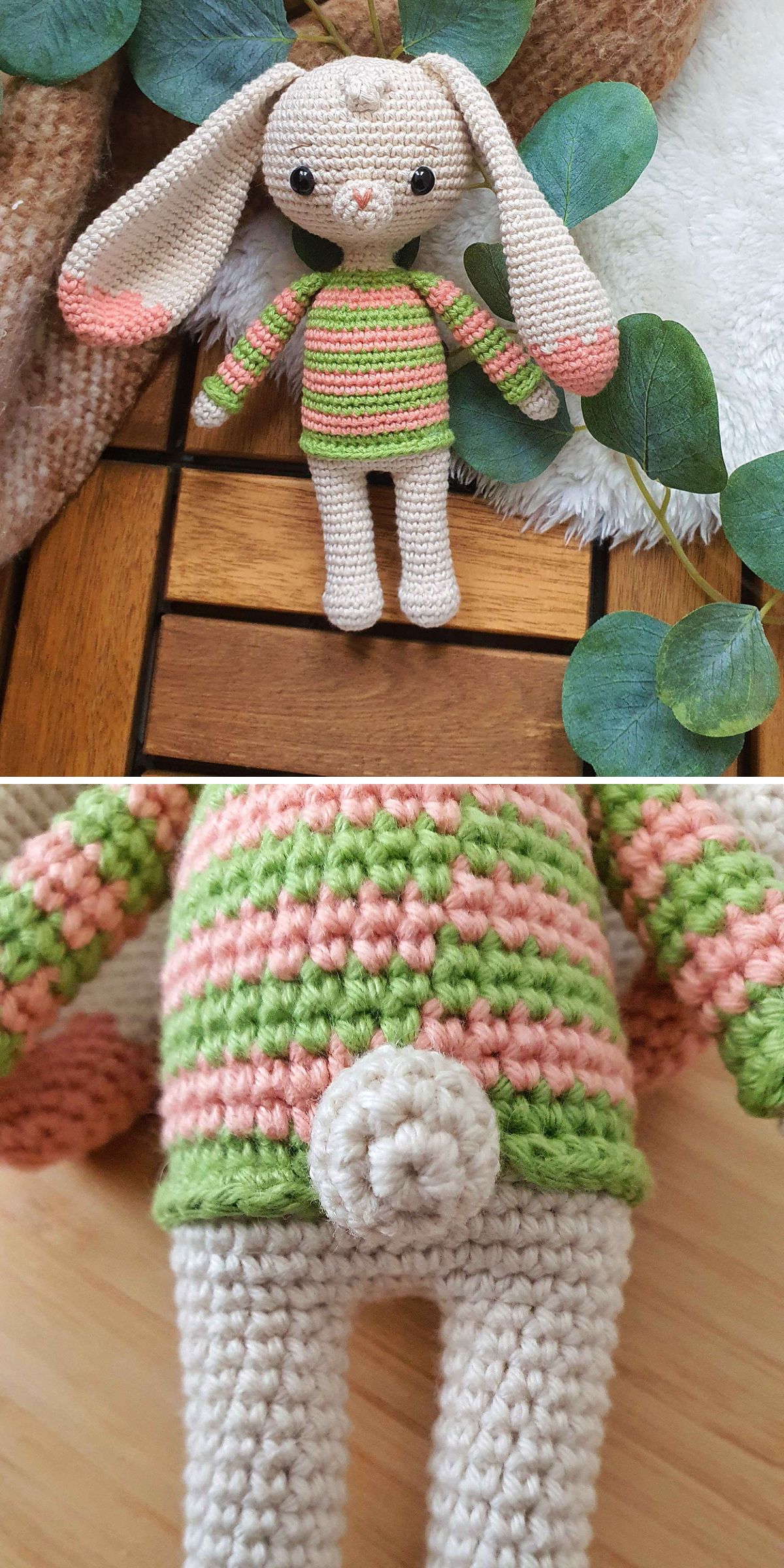 A crochet bunny toy with long ears, a striped green and pink sweater, and a small round tail is shown lying on a wooden surface with leaves nearby.