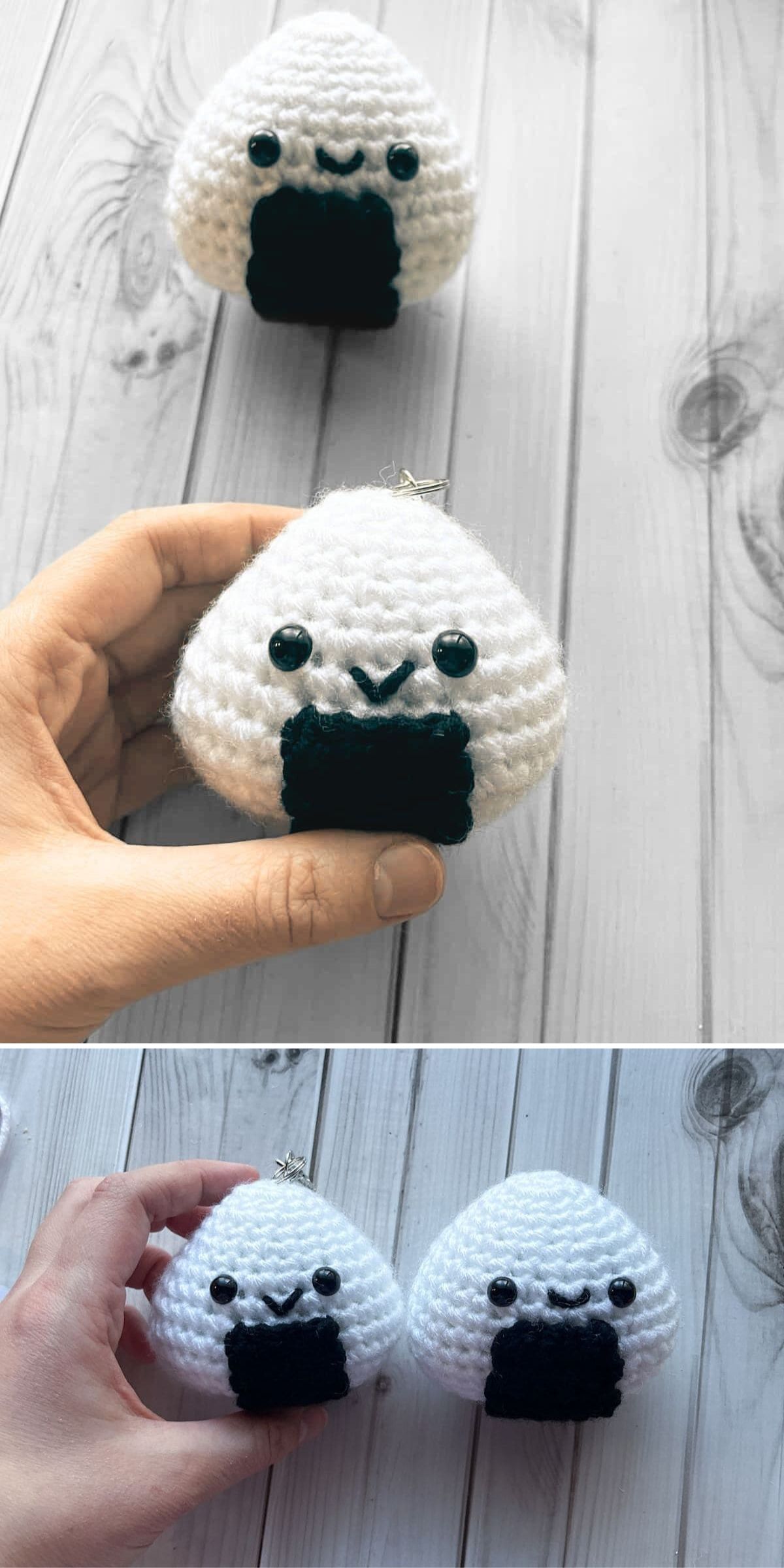 Hand holding a small food amigurumi crocheted onigiri with a smiling face and black felt detail, next to another similar crocheted onigiri on a wooden surface.