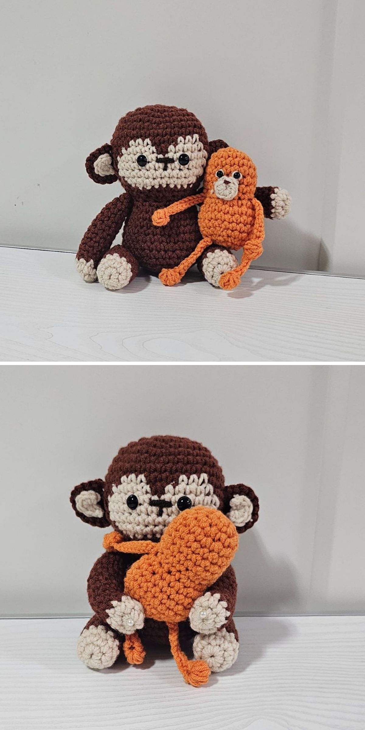 Two crocheted stuffed animals, a brown crochet monkey and a smaller orange monkey, sit together on a light surface. The brown monkey hugs the orange monkey.