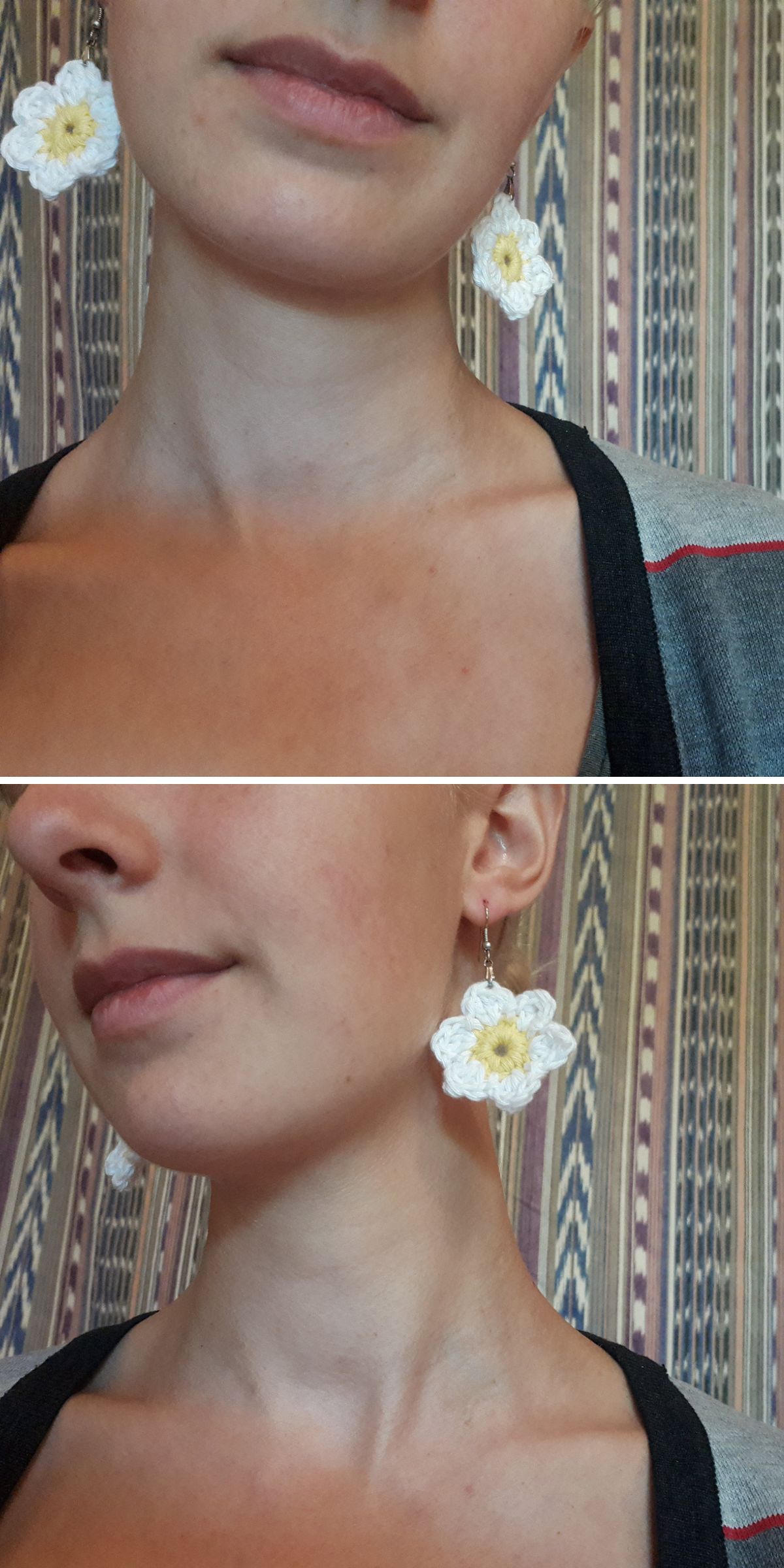 A person wearing crochet earrings shaped like white flowers with yellow centers stands in front of a patterned background.