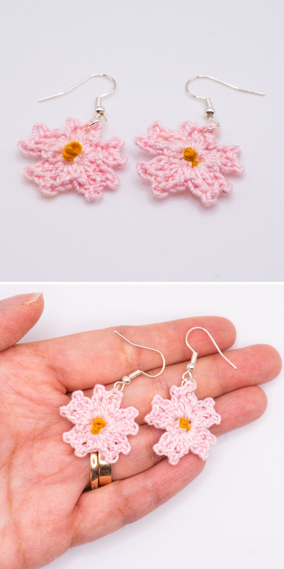 Two pink crochet earrings shaped like flowers with yellow centers; displayed on a white background and also held in a hand to show scale.