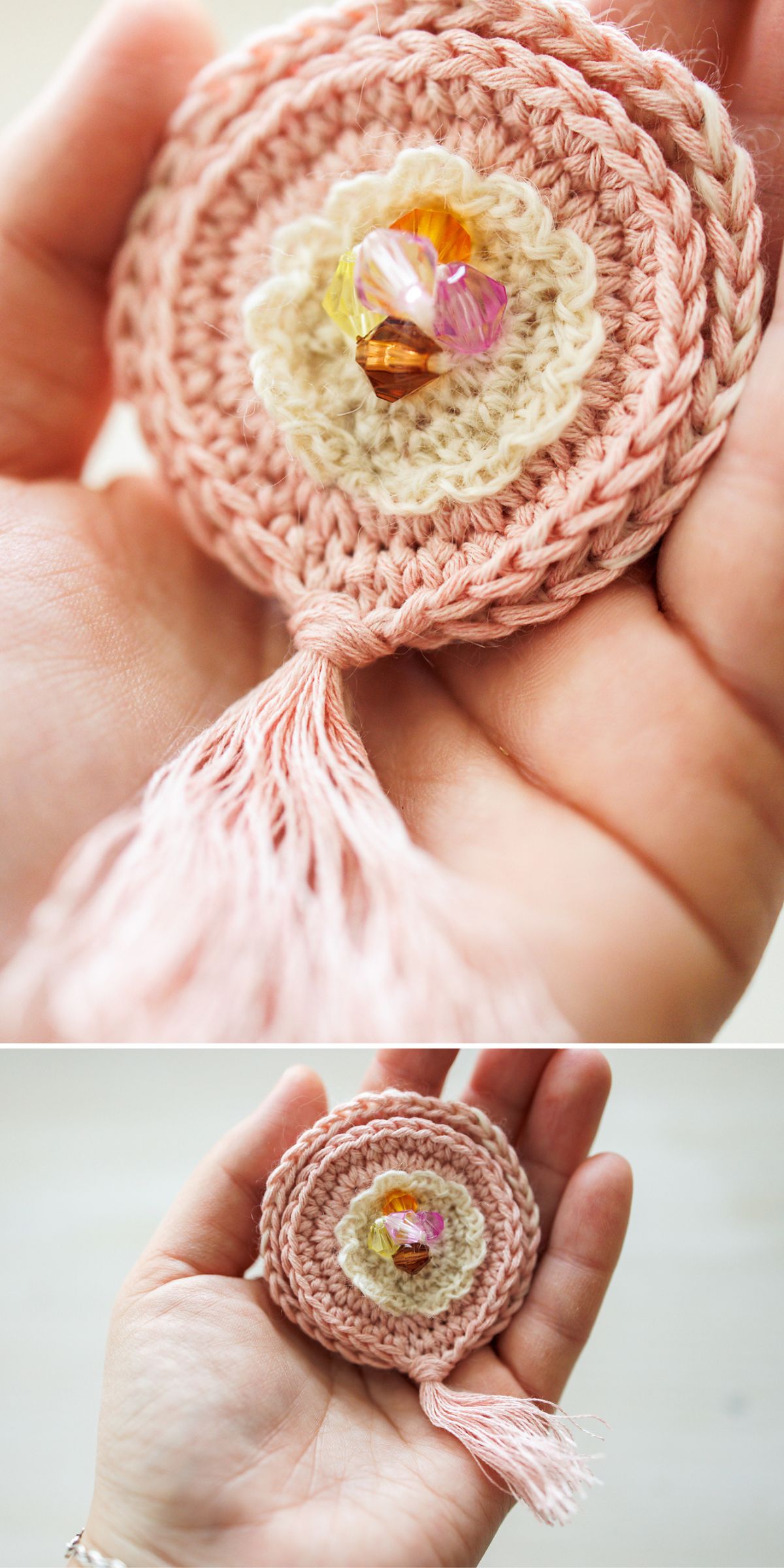 a dusty pink, beautiful crochet brooch resembling a mandala with a few beads in the center and a fringe