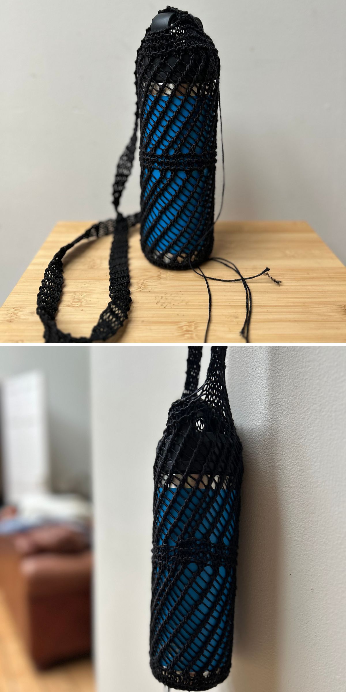 A blue water bottle inside a black knit water bottle holder is shown on a wooden surface and hanging on a wall.